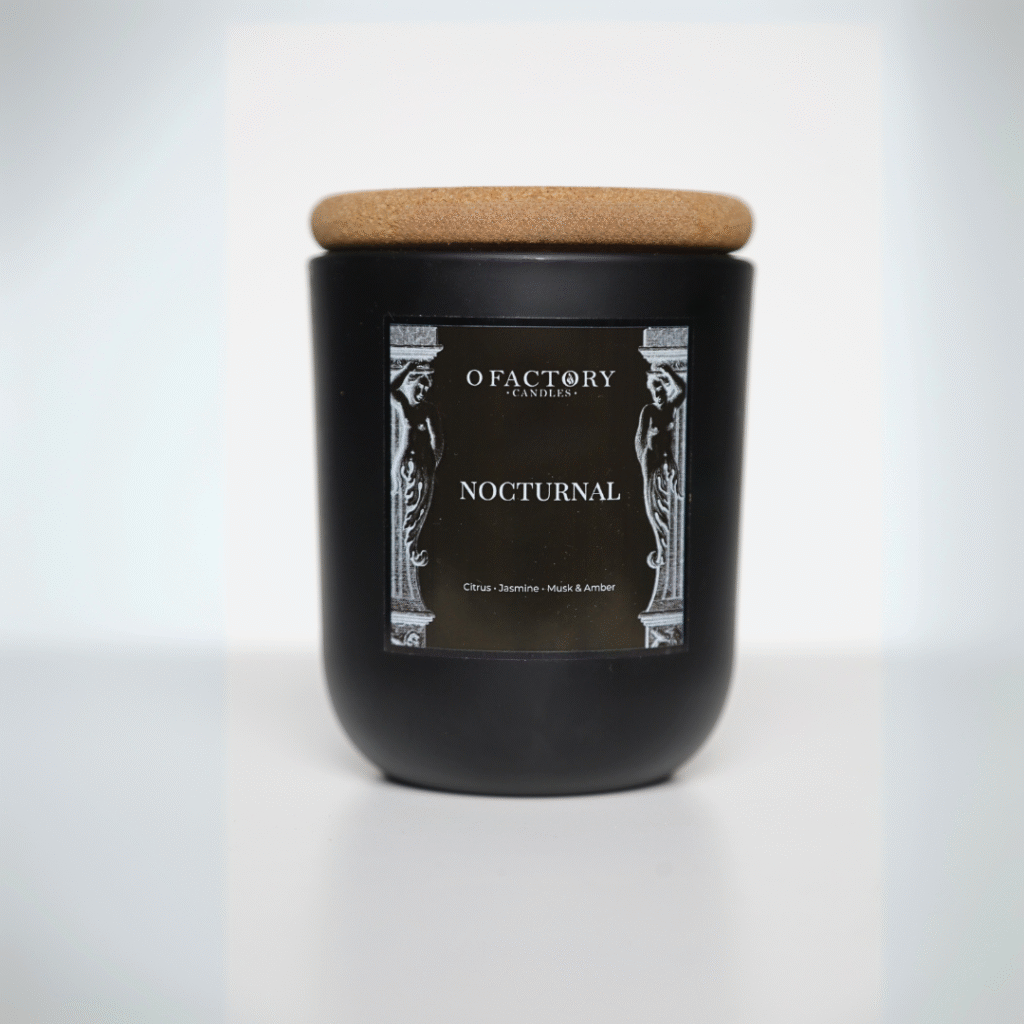 Nocturnal candle with citrus, jasmine, and amber scent in black jar