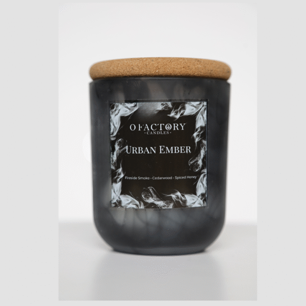 Urban Ember candle with fireside, cedarwood blanc, cinnamon stick, spiced honey, and tonka scent in black glass jar, hand-poured coconut apricot wax